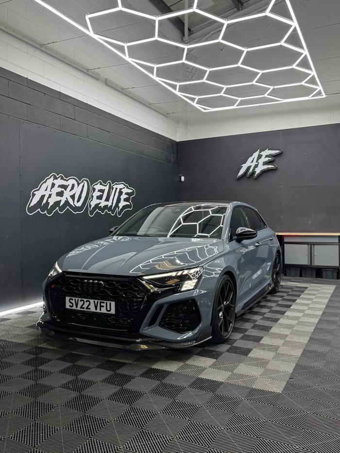 Audi RS3 8Y front three-quarter hero shot after wheel, splitter and spoiler fitment