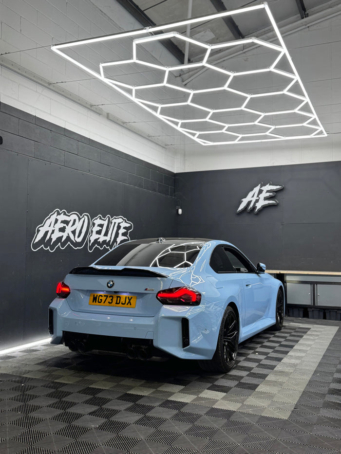 BMW M2 (G87) after carbon fibre spoiler fitment by Aero Elite, rear three-quarter view