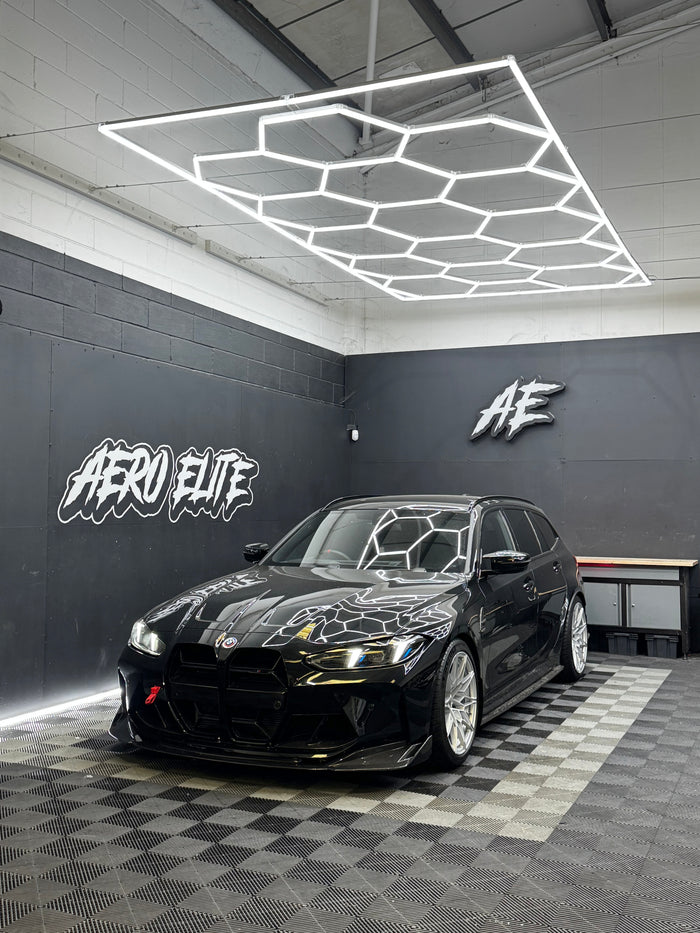 BMW M3 Touring G81 front three-quarter hero shot after front splitter fitment and wheel refinishing