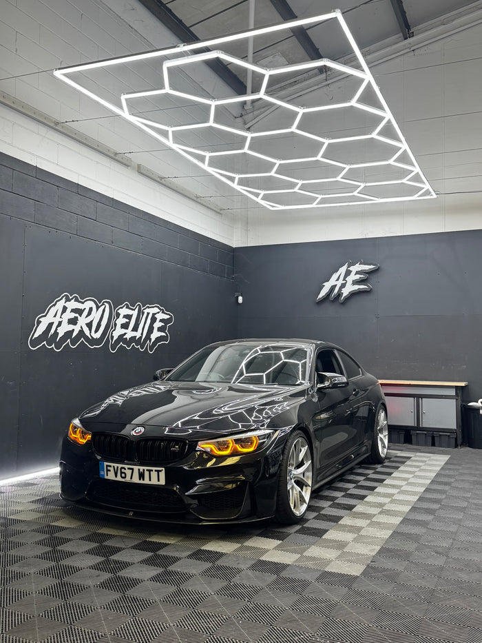 BMW M4 F82 front three-quarter hero shot after coilover suspension fitment, lowered stance