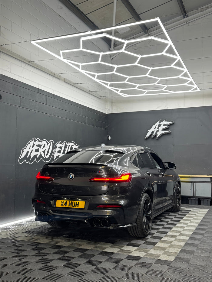 BMW X4M (G02) Competition with quad exhaust upgrade by Aero Elite, rear three-quarter view