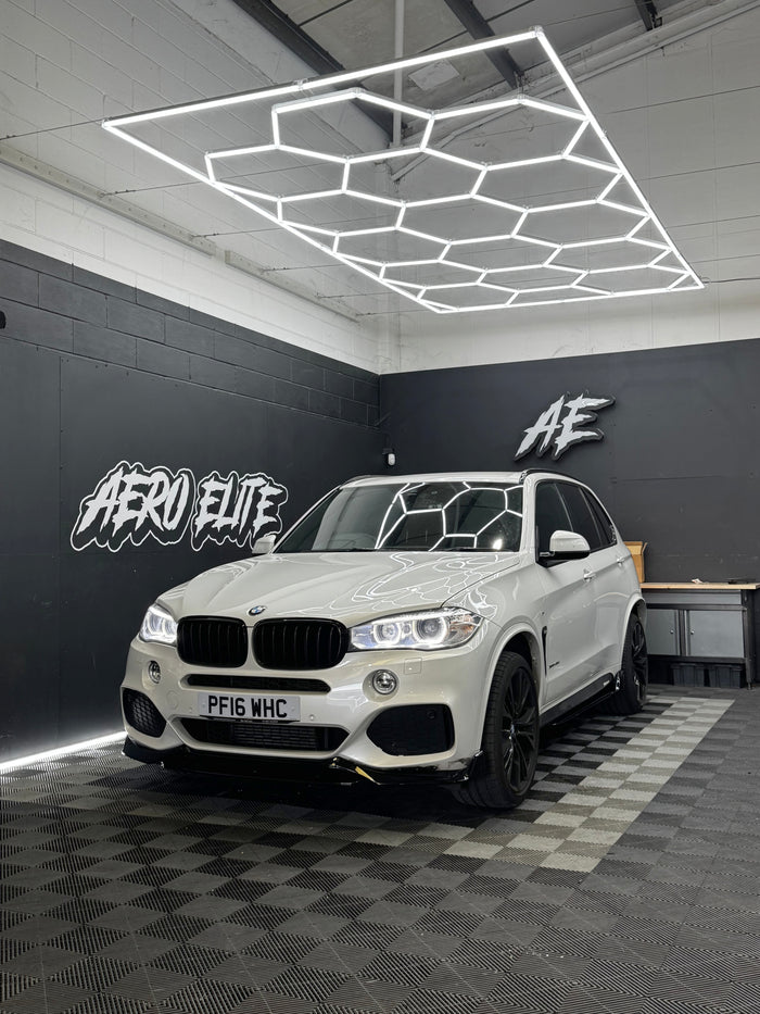BMW X5 (F15) with front splitter, side skirts, diffuser and spoiler by Aero Elite, front three-quarter view