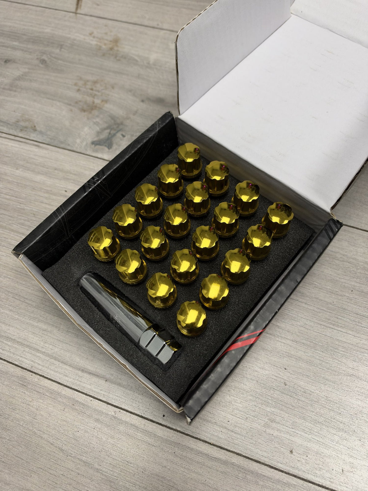 Actual in-stock set: Japan Racing JB1 gold M12x1.5 wheel bolts, boxed with key
