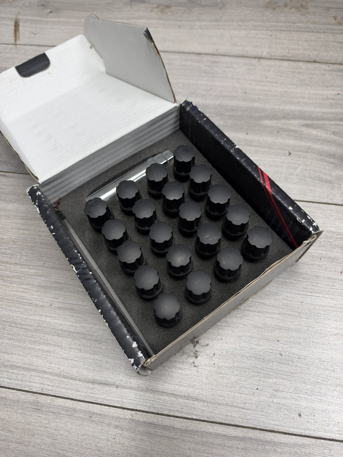Actual in-stock set: Japan Racing JB1 black M12x1.25 wheel bolts, boxed with key
