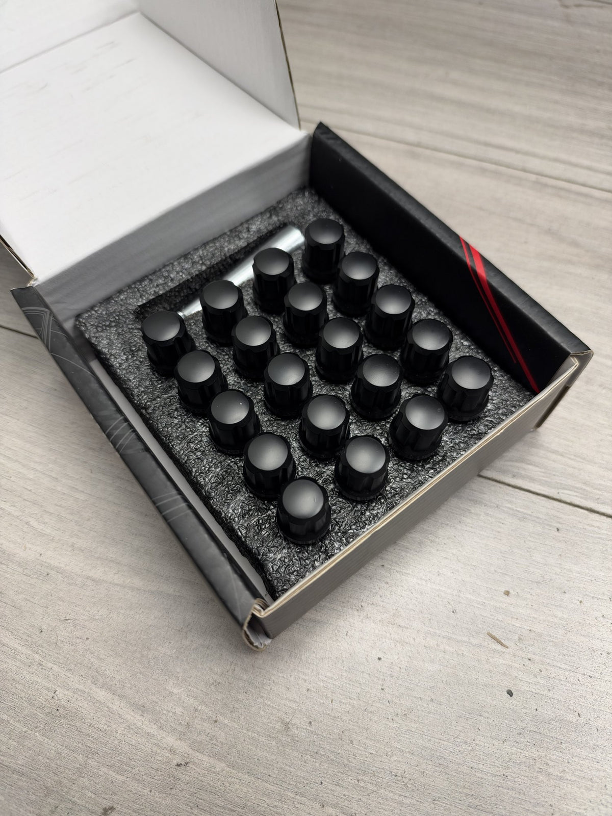Actual in-stock set: Japan Racing JB1 black M14x1.25 wheel bolts, boxed with key