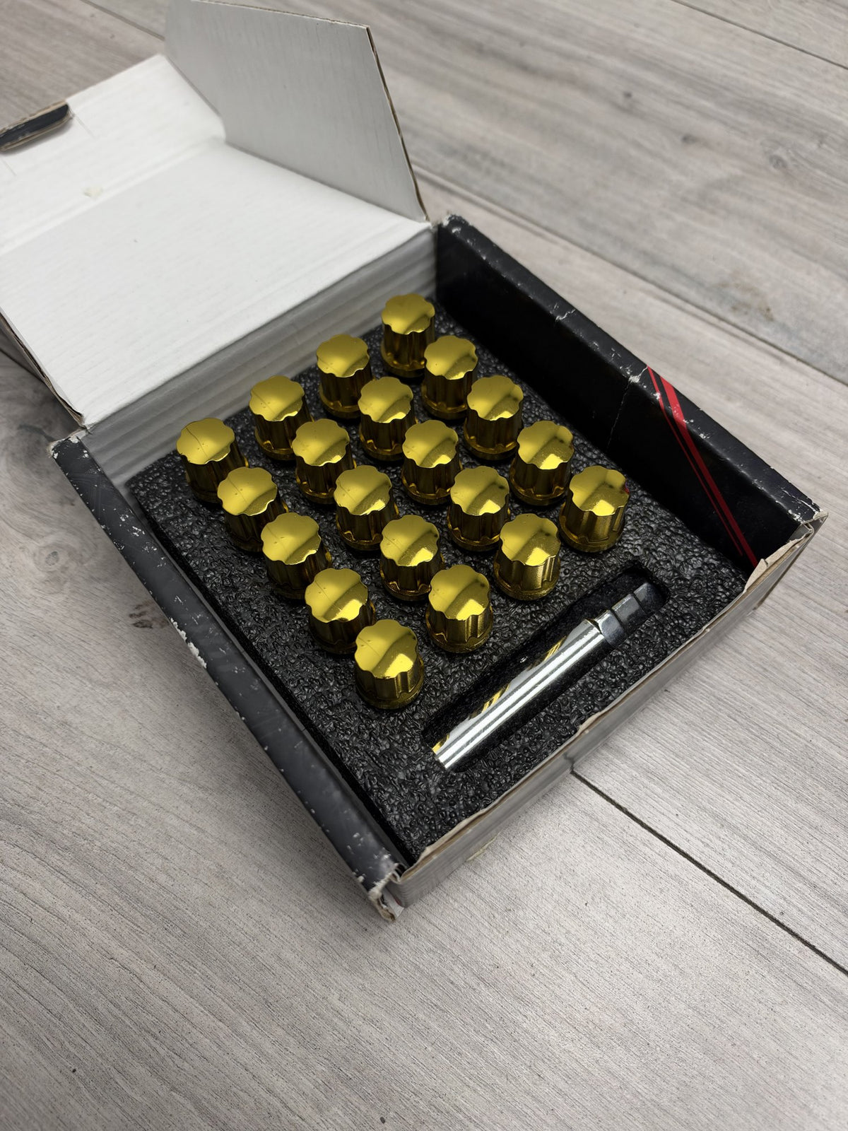Actual in-stock set: Japan Racing JB1 gold M12x1.25 wheel bolts, boxed with key