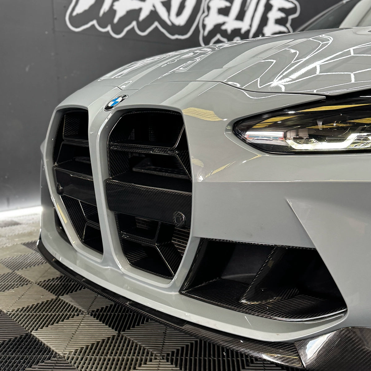 Close-up of a BMW M3 Carbon Fibre CSL Grille with a blurred background