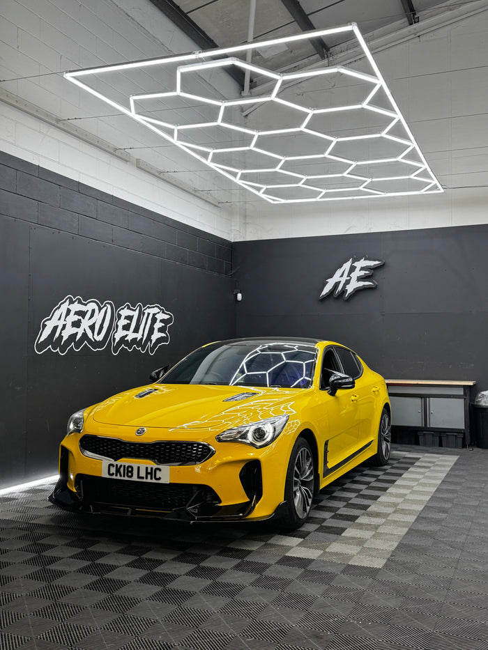 Kia Stinger with gloss black front splitter by Aero Elite, front three-quarter view