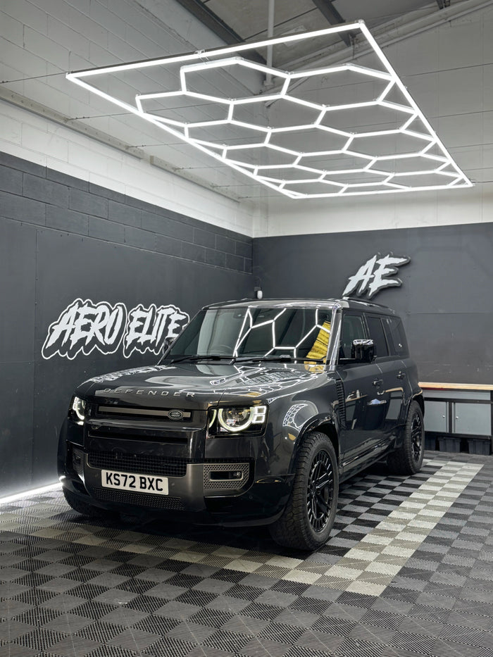 Land Rover Defender 110 L663 after new alloy wheel fitment — front three-quarter view