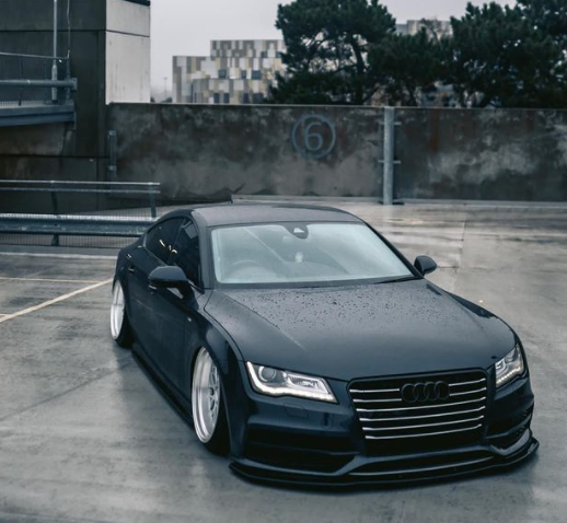 Lowered Audi A7 fitted with a front splitter showcasing aggressive performance styling